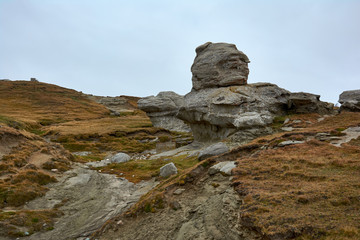 Fototapeta na wymiar Mountain landscape in Bucegi Natural Park near Busteni, Romania. Megaliths on top of a mountain range, tourist attraction.