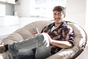 successful young man reading SMS on his smartphone