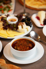 close up of borscht russian-style beet soup served in bowl