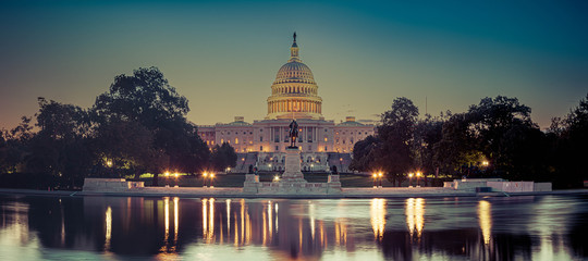 Panoramic image of the Capitol of the United States with the capitol reflecting pool in morning...