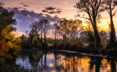 Autumn sunset on the river Sile at Casale sul Sile (Italy). Trees and countryside landscape