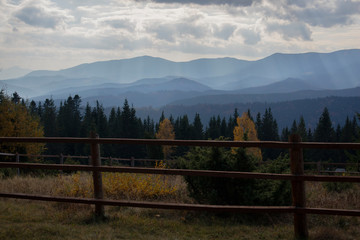 Fence in the countryside. Forest in the mountains.