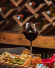 glass of red wine served with cheese plate