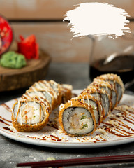 hot fried sushi rolls with teriyaki sauce and spicy cream