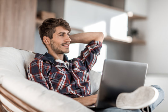 close up. successful young man sitting in front of an open laptop