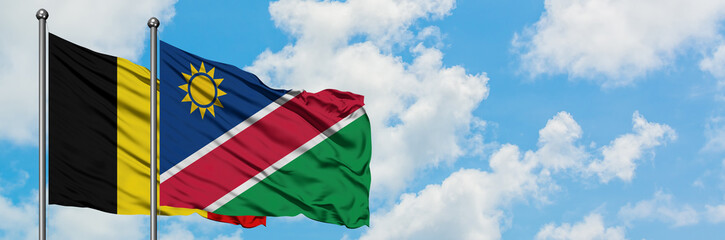 Belgium and Namibia flag waving in the wind against white cloudy blue sky together. Diplomacy concept, international relations.