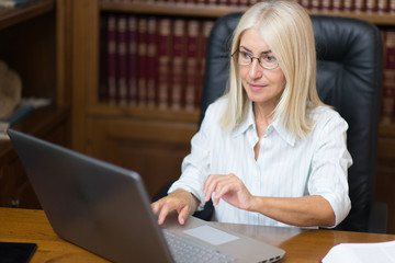Fototapeta na wymiar Mature woman using her laptop computer