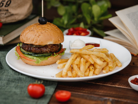 small beef buger with lettuce, cucumber, tomato and french fries