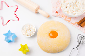 Home cooking. Blank for baking. Cottage cheese, eggs, dough and baking dish in the form of stars on a white background.
