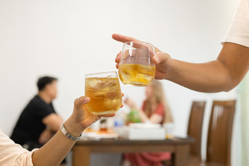 Friends toasting glass of whiskey celebration in restaurant.