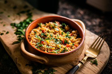 A bowl of paella in wood