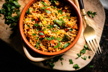 A bowl of paella in wood