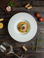 top view of meat soup garnished with raddish, coriander, and dried tomato 1