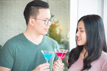 Young Asian couples are celebrating Christmas festivities in a warm, fun-filled, holiday-filled, high-end Christmas and New Year holiday concept.