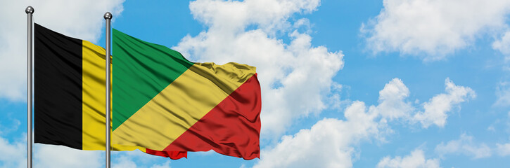 Belgium and Republic Of The Congo flag waving in the wind against white cloudy blue sky together. Diplomacy concept, international relations.
