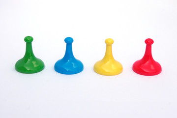 different colored board game movers on white background © stephaniemurton