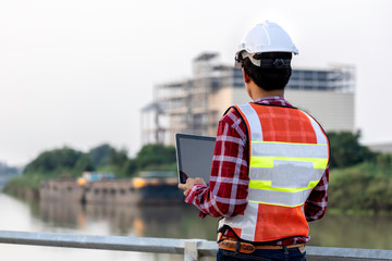 Engineer are working contruction on site plans to build high-rise buildings. Engineer building...