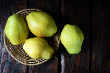 Group of pears on a dark wooden background. Organic foods, healthy nutrition.
