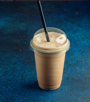 Top View Of Plastic Cup Of Coffee Latte With Black Straw