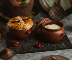two small pots of azerbaijani pilaf rice and meat with dried fruits
