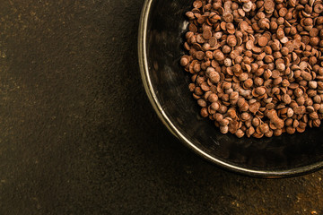 chocolate drops (black or milk chocolate, sweet ingredient) menu concept. food background. copy space. Top view