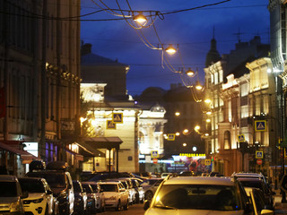 Night city. Street, illumination and lights, parked cars. Saint Petersburg, Russia