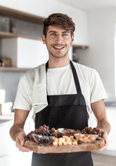 attractive young man showing them cooked Breakfast