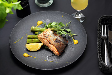 Grilled salmon on green asparagus. An elegant exquisite dish.