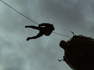 Landing of special forces on a rope from a helicopter	