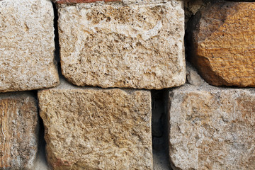 The rough masonry of large blocks of an ancient structure, like a texture of a stone wall of large blocks.