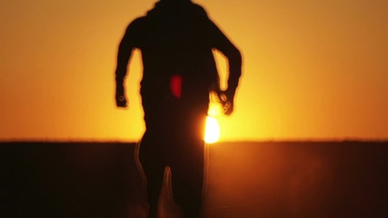 warrior with Kalashnikov at sunset day. fighter is training with a machine gun at sunset.