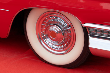 Red Retro Car Wheel on a Red Carpet