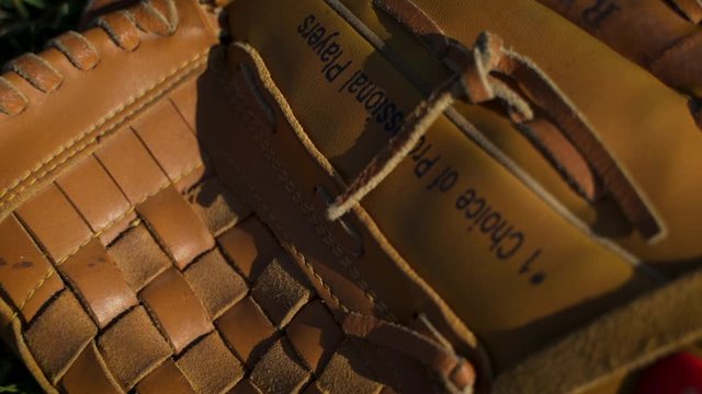 Close Up Of An Older Baseball Glove On The Ground.