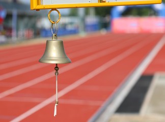bell to indicate to the athletes the last lap of the race