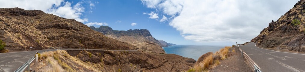 Fototapeta na wymiar Panorama of costal road GC 200 on Gran Canaria winding its way along the west coast of the island. View of Tamadaba National Park an the Atlantic Ocean on a sunny day.