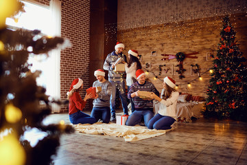 Content friends exchanging with presents in house