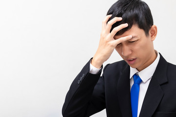 Business men wear black suits Headache from stress. Disappointed by work and profits. There is copy space on the left.