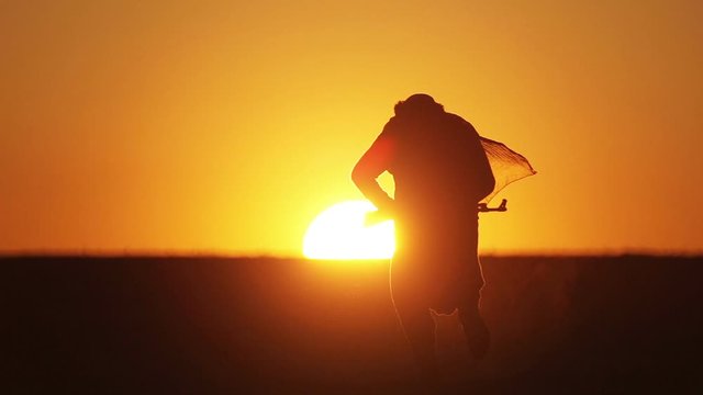 warrior with Kalashnikov at sunset day. fighter is training with a machine gun at sunset.