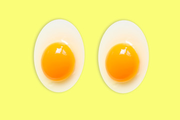 Pair Eggs Organic Oval  oblong  (White eggs and  yolk )of chicken Cooked high protein good for health decorative food pattern isolated on  Pastel Yellow background texture close-up