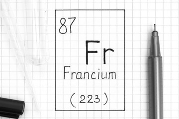 The Periodic table of elements. Handwriting chemical element Francium Fr with black pen, test tube and pipette.