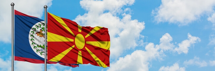 Belize and Macedonia flag waving in the wind against white cloudy blue sky together. Diplomacy concept, international relations.
