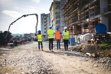Group of construction workers on building site.Stock photo