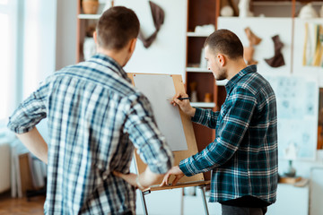 An engineer explaining his idea to his partner.