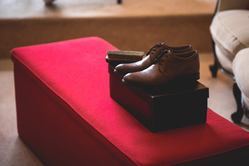 Casual  brown leather male shoes placed on a cardboard box