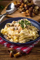 Tagliatelle pasta with forest mushrooms and chicken.