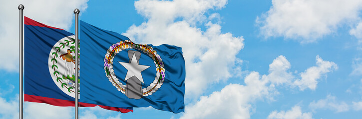 Belize and Northern Mariana Islands flag waving in the wind against white cloudy blue sky together....