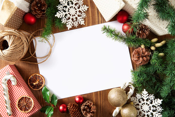 Christmas greeting card with copy space on a wooden background viewed from above. Top view
