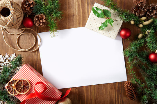 Christmas greeting card with copy space on a wooden background viewed from above. Top view