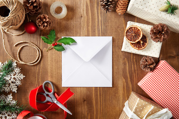 Christmas letter with copy space on a wooden background viewed from above. Top view. Christmas greeting card