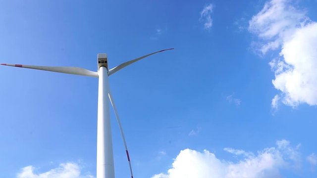 The technology of renewable energy from wind turbines and bright skies footage timelapse